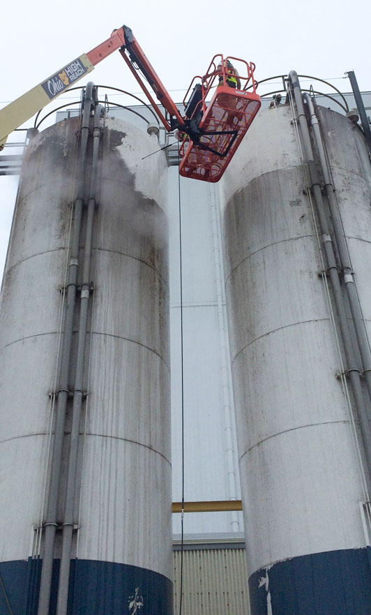 Media blasting exterior of silos