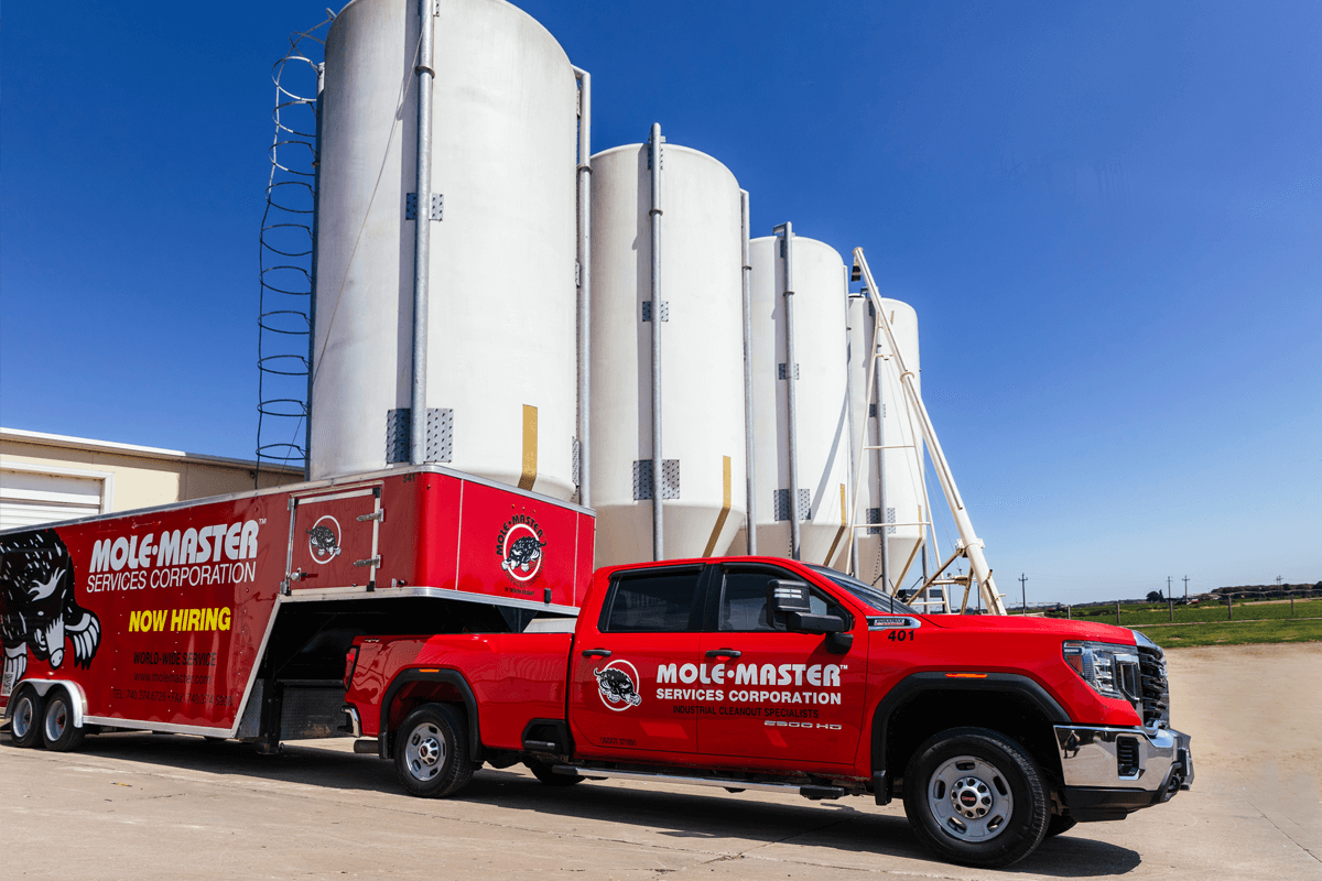 Mole&middot;Master&reg; equipment truck on-site for pipe cleaning service alongside silo operations