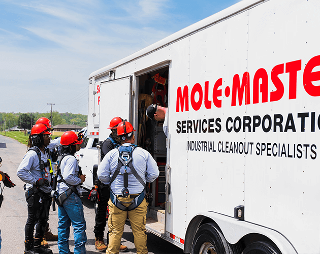 Workers receiving job instructions beside the trailer