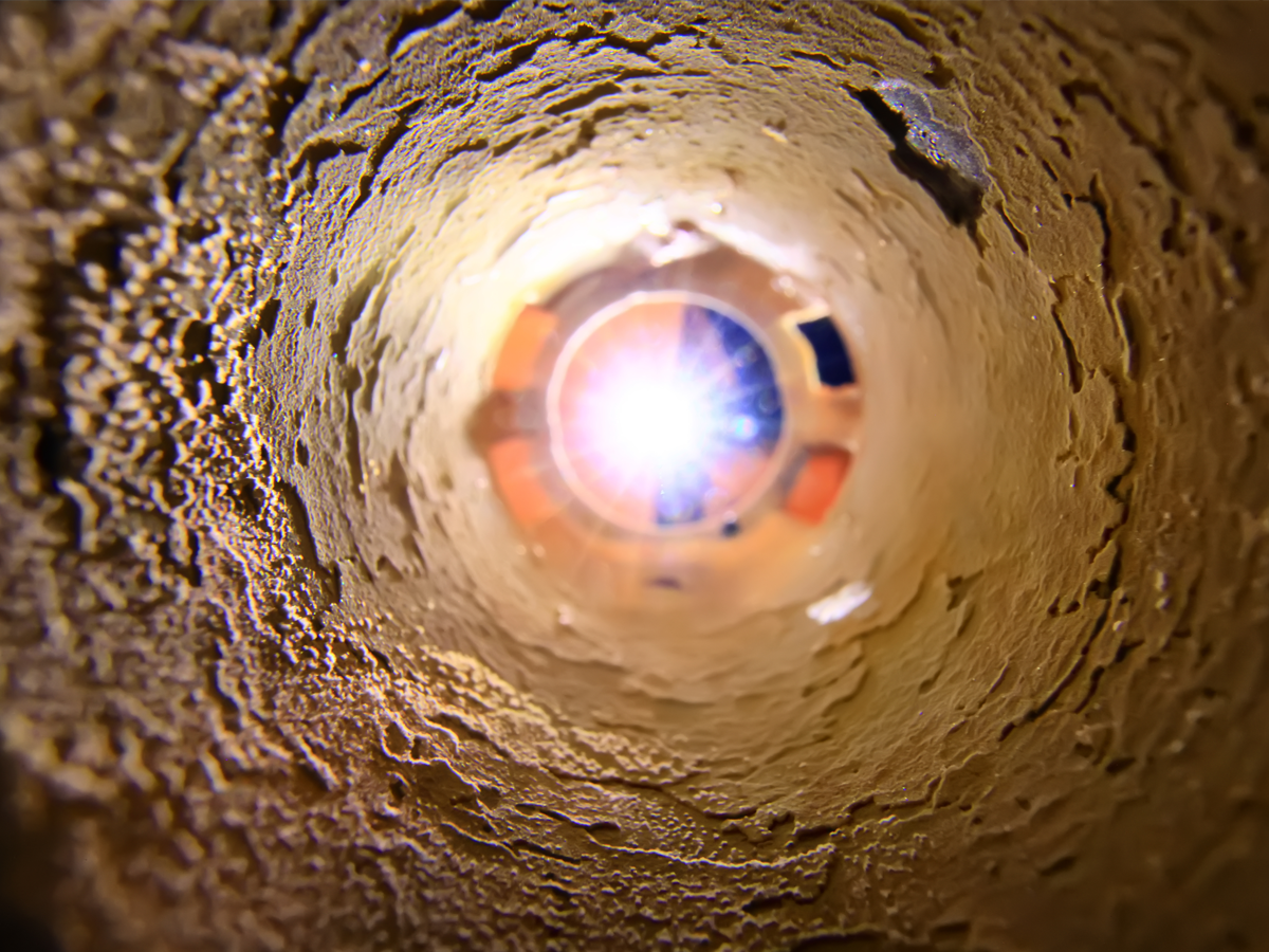 Interior of industrial pipe with heavy scale buildup: hydro lancing required for clearance
