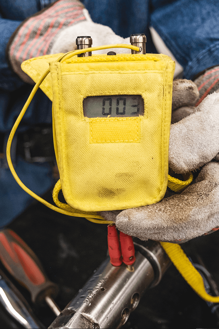 Mole&middot;Master&reg; worker preparing Safe-T-Shot&reg; deployment at a cement silo discharge outlet