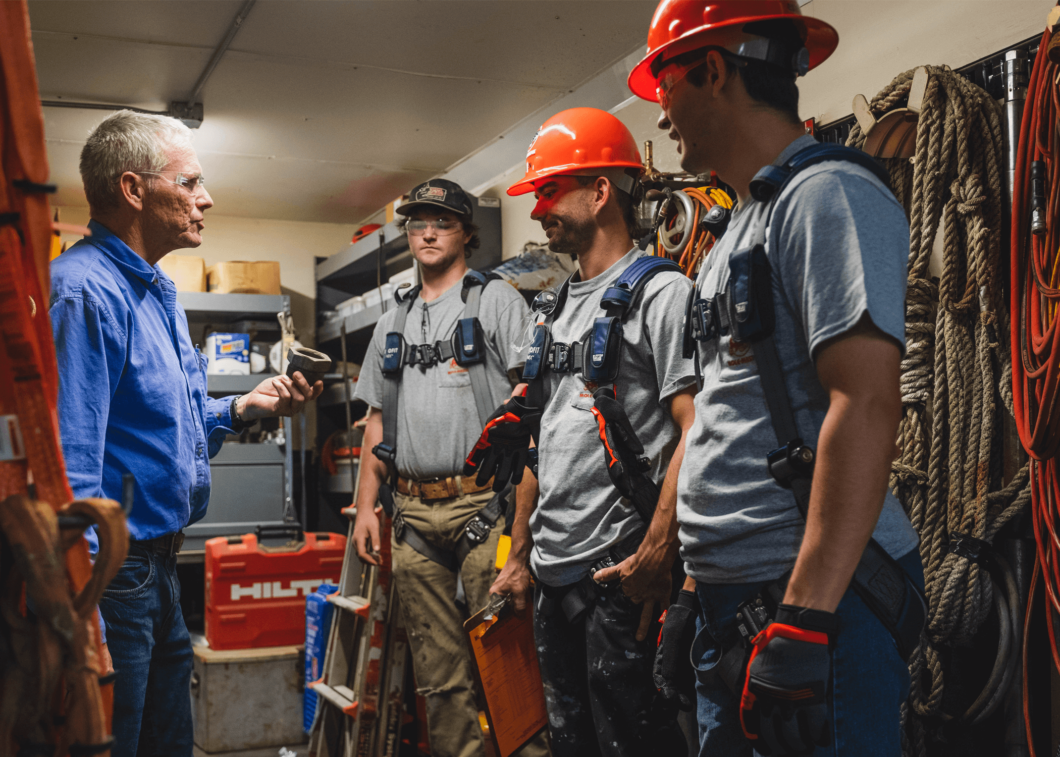 Workers being trained on confined space PPE and atmospheric monitoring equipment