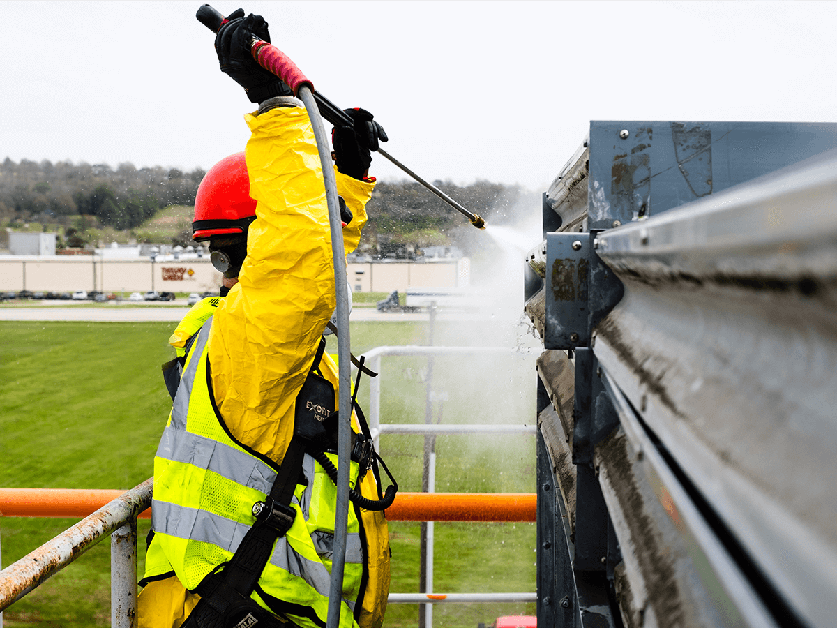 Abrasive blasting crew preparing industrial surface for coating