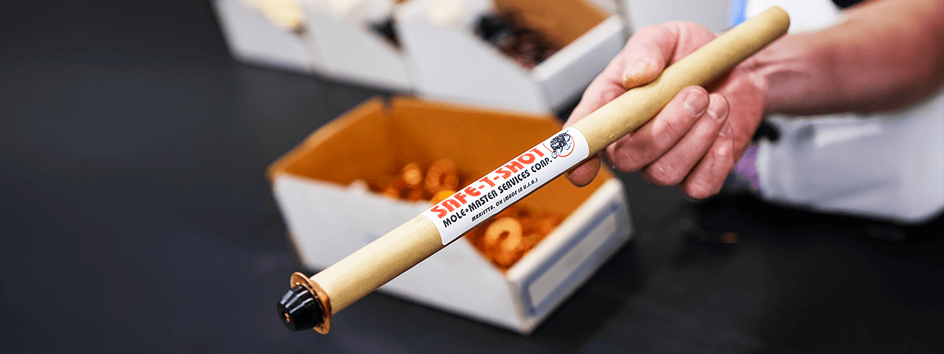 Safe-T-Shot&reg; device close-up: CO₂ tube held in operator's hand before deployment