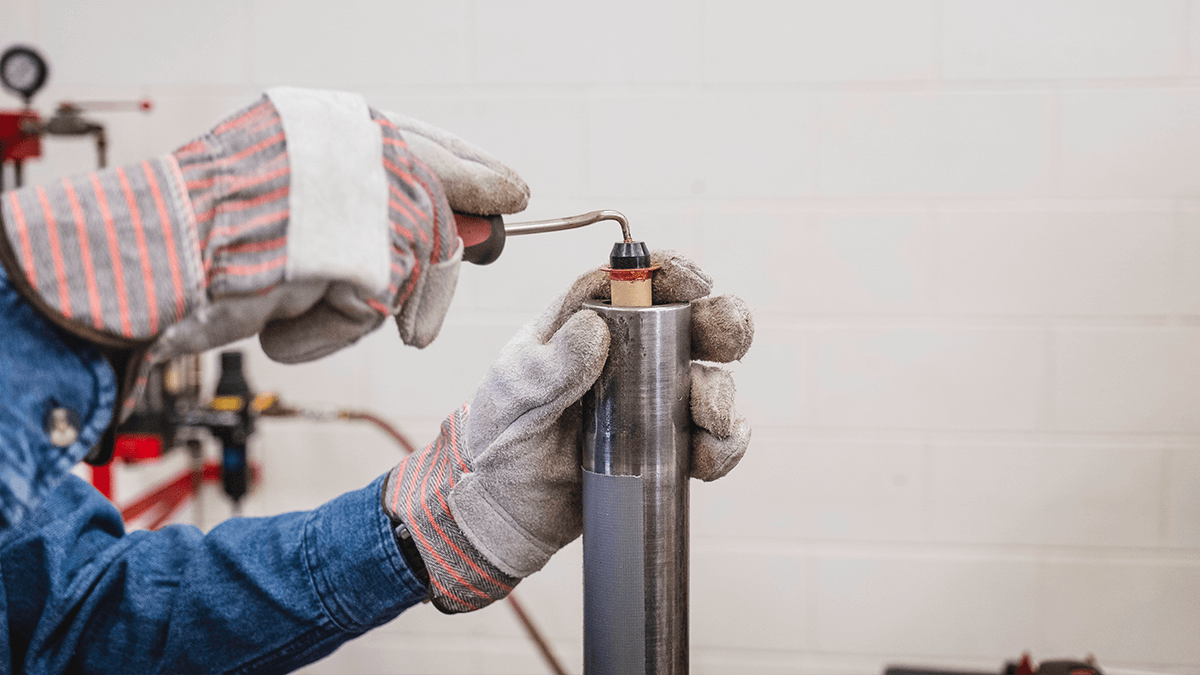 Technician inserting Safe-T-Shot&reg; CO2 cartridge: non-sparking CO2 blasting for hardened grain build-up