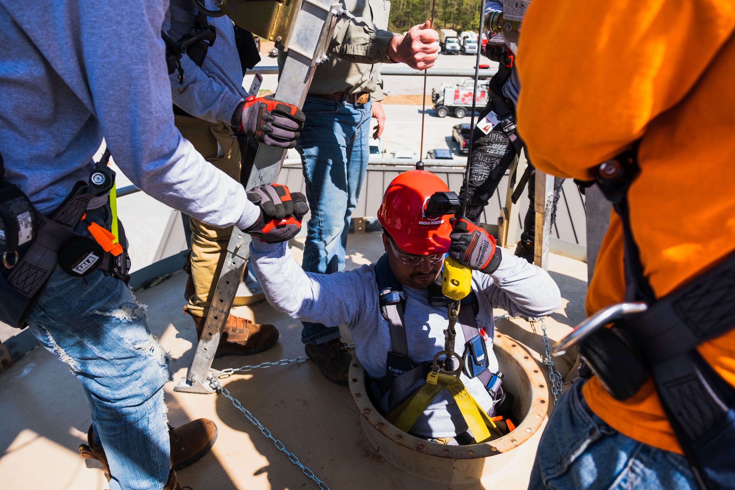 Crew member being lowered into the Mole&middot;Master&reg; training silo using full safety equipment
